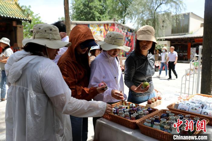 圖為民眾挑選手工藝產(chǎn)品?！⊙Φ?攝